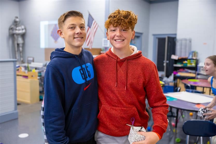  Two boy students smiling in the art room